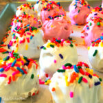 pink and white cake balls with sprinkles