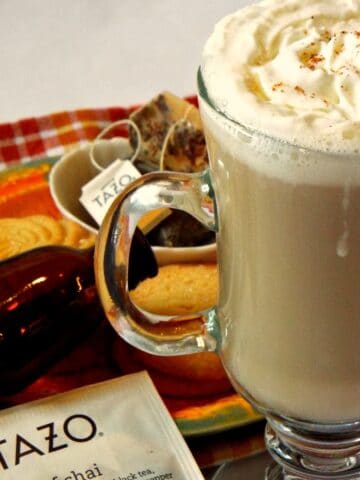 A cup of latte tea topped with whipped cream