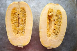 Spaghetti squash cut in half with seeds