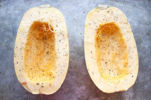 Spaghetti squash cut in half with salt and pepper