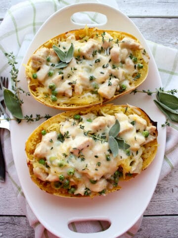 top view of Spaghetti squash in white dish with herbs