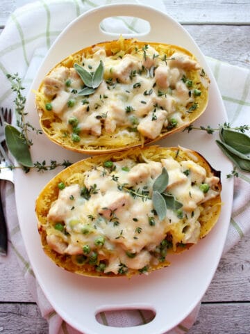 top view of Spaghetti squash in white dish with herbs