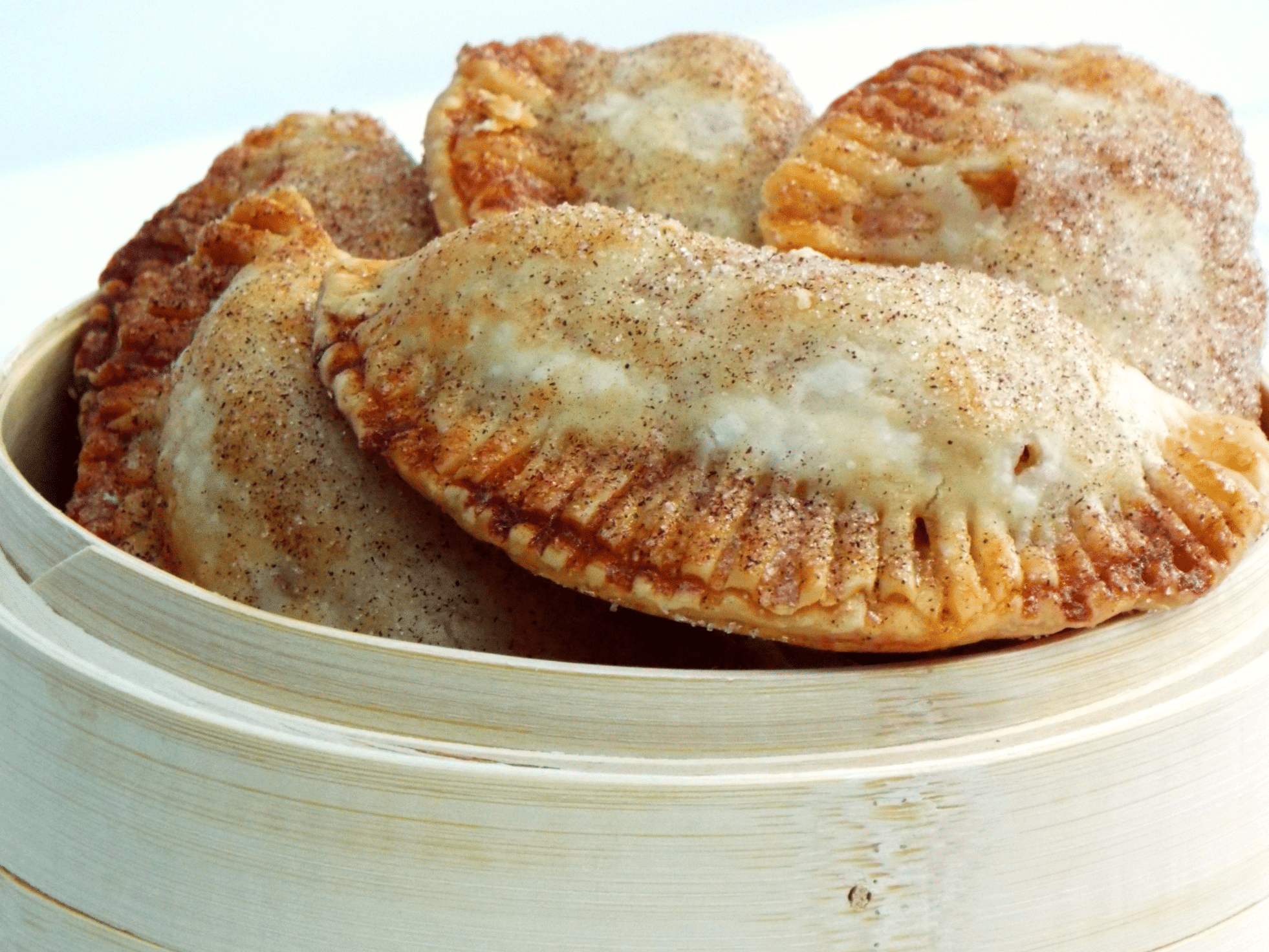 a basket filled with small apple hand pies