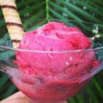 bowl of hot pink ice cream and a swirl cookie