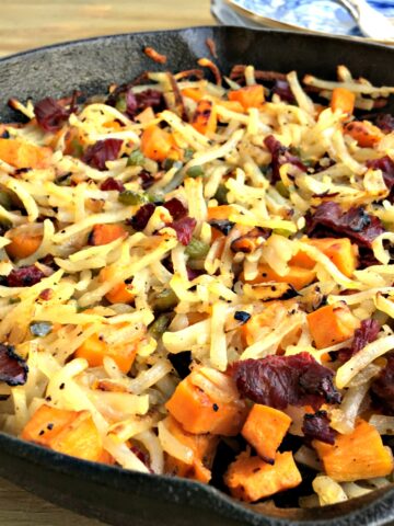 A pan filled with food, with Pastrami and Potato