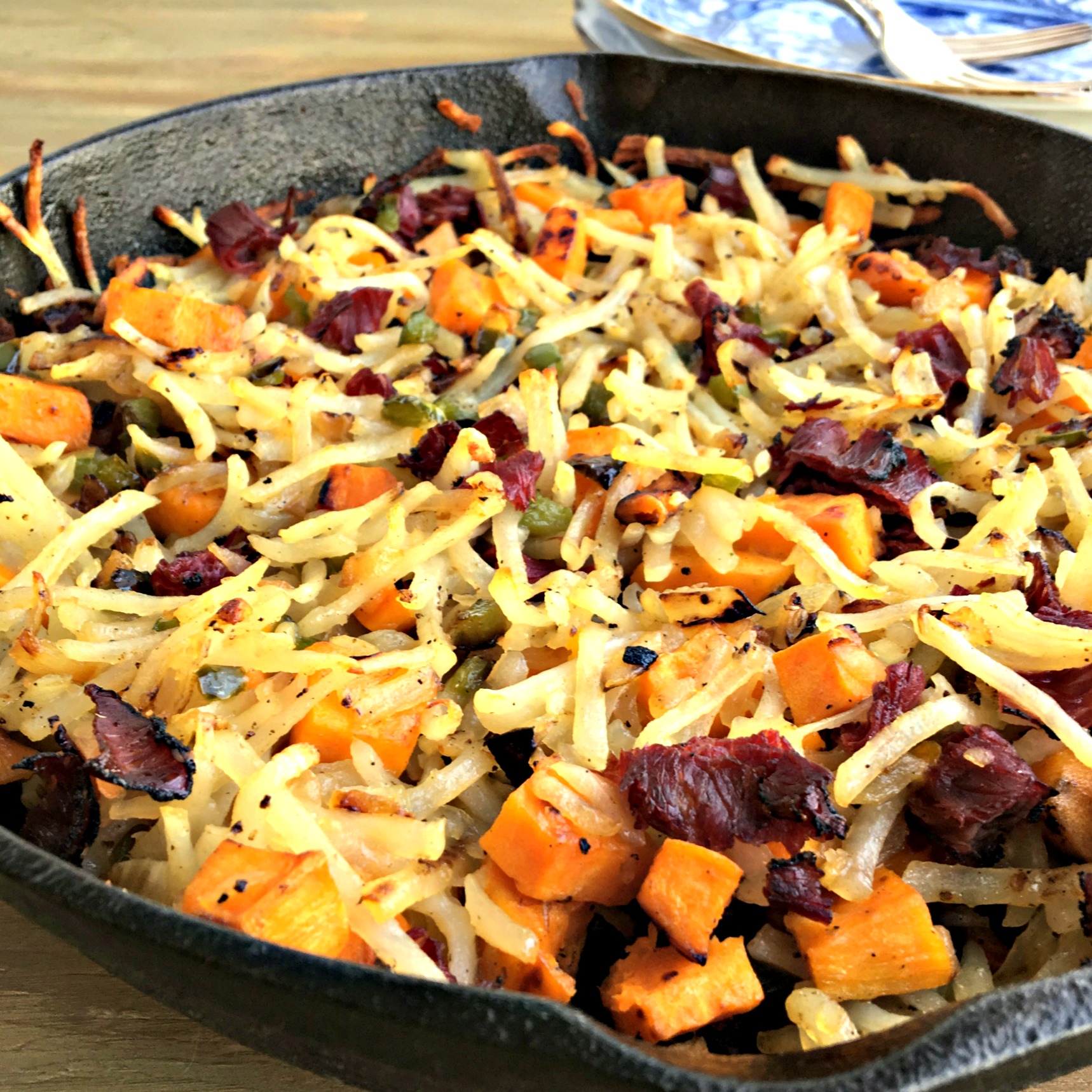 A pan filled with food, with Pastrami and Potato