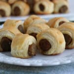 close up of a plate of sausages rolled in pastry