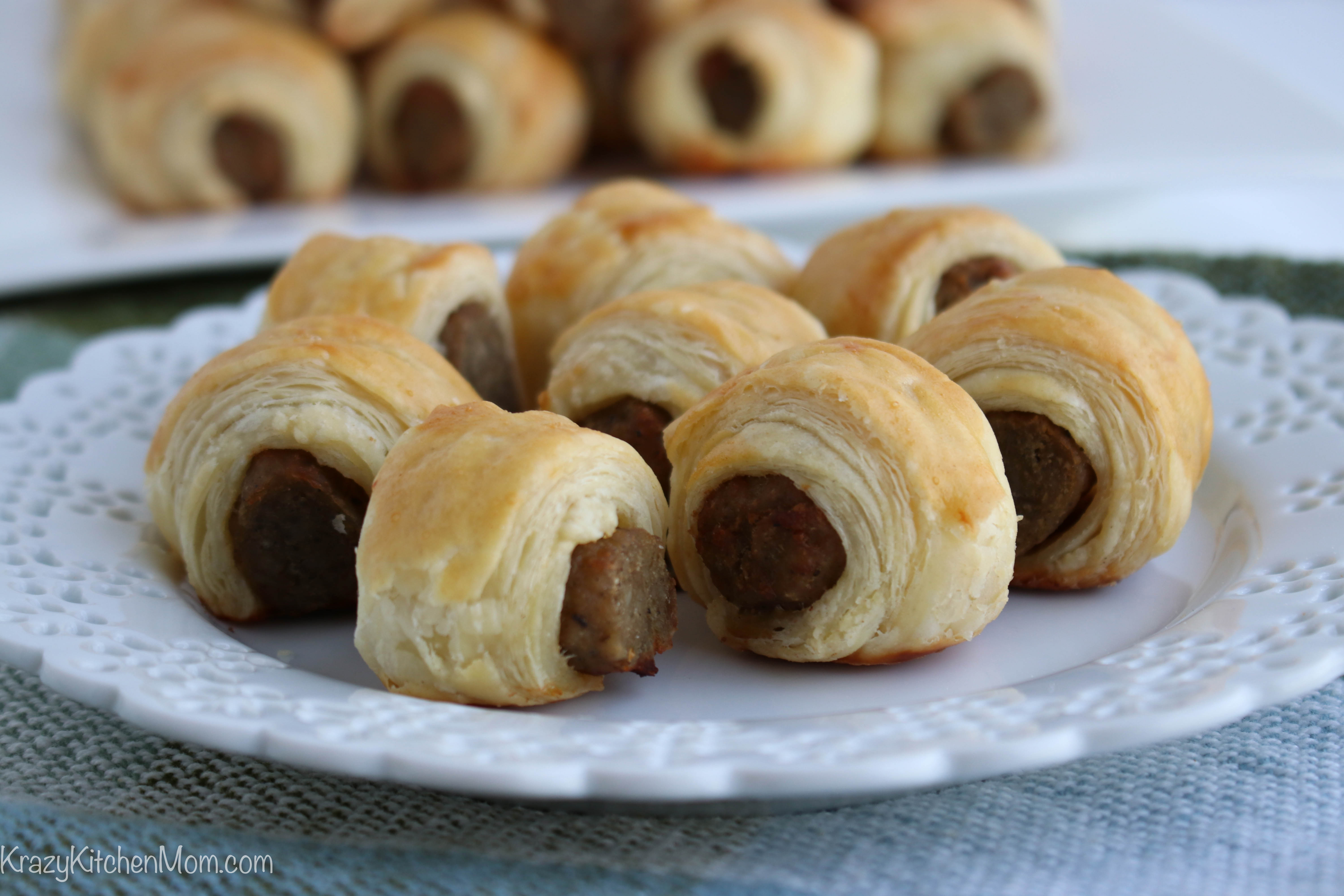 close up of a plate of sausages rolled in pastry