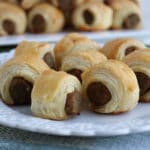 close up of a plate of sausages rolled in pastry