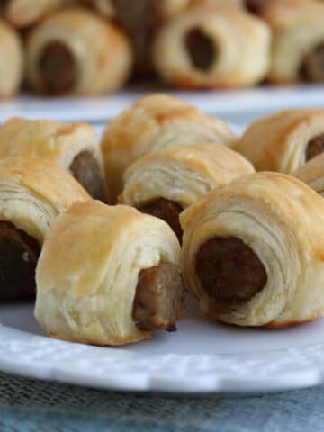 close up of a plate of sausages rolled in pastry