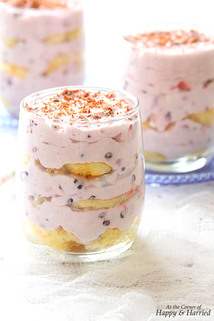dessert dish layers with berries, cake and cream
