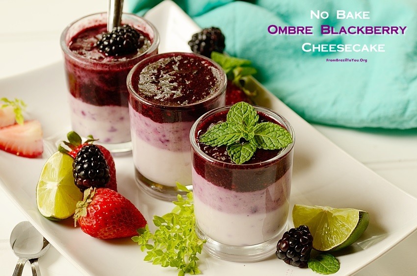 3 dessert dishes filled with layers blackberry cheese cake topped with blackberries and fresh mint