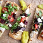 flatbread topped with Greek salad and peppers