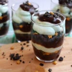four parfaits with chocolate cake, mint pudding and little gold star sprinkles