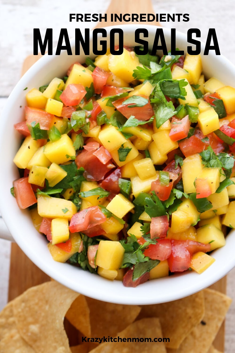 Fresh Mango Salsa is bursting with bright sweet flavors from the perfectly ripened mango and bright red tomatoes with a hint of heat from a jalapeno.  via @krazykitchenmom