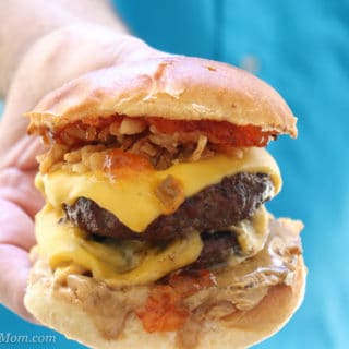 man holding one burger
