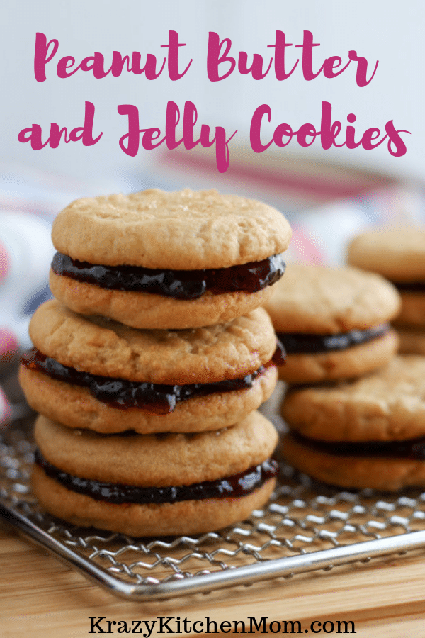 Two peanut butter cookies sandwiched together with grape jelly make the best Peanut Butter and Jelly Cookies. Crunchy, creamy, sweet - everything you remember in a delicious little three-bite cookie. via @krazykitchenmom