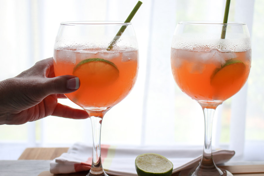 two Paloma Aperol Spritz Cocktails with hand