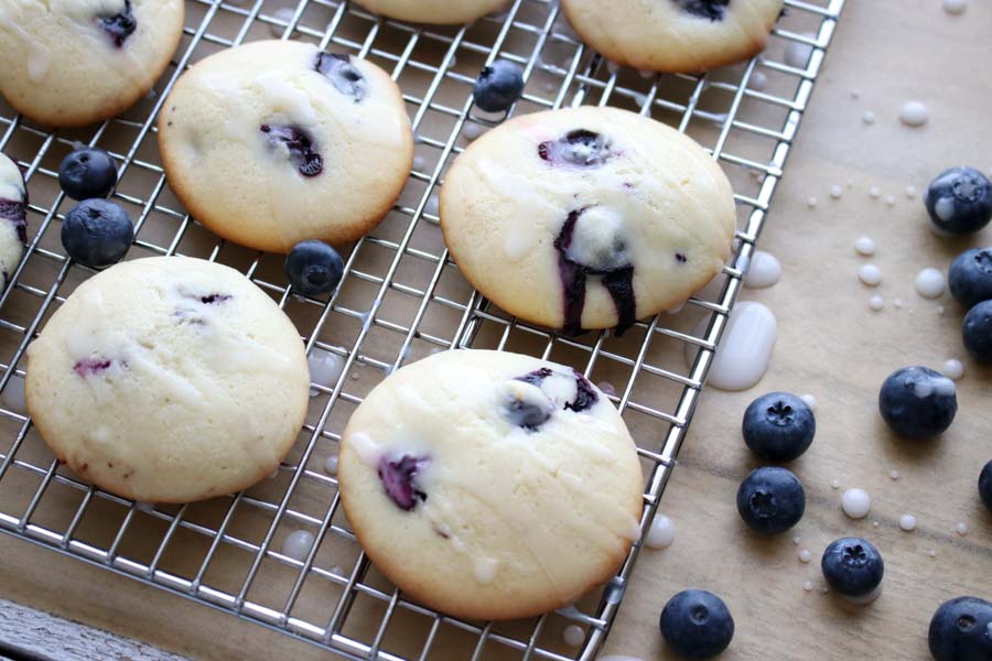 blueberry muffin tops on a rack