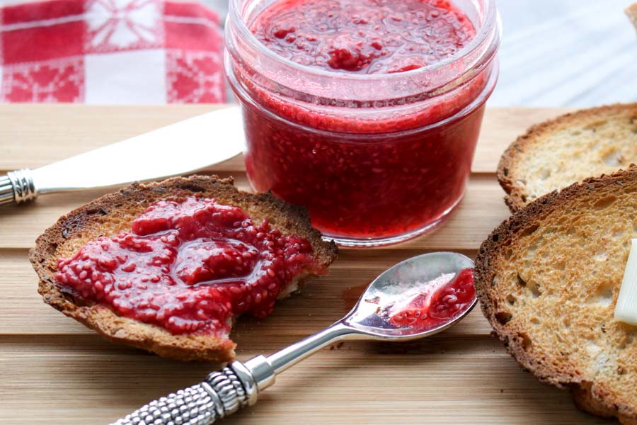 Jar of chia jam with spoon and piece of toast