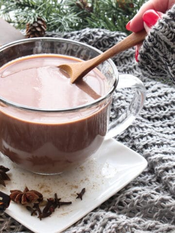 hand stirring chai hot chocolate