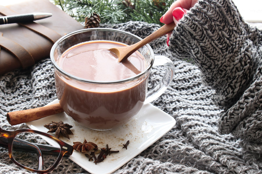 hand stirring chai hot chocolate