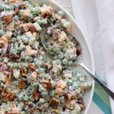 Bowl of Bacon Peas Salad with a spoon