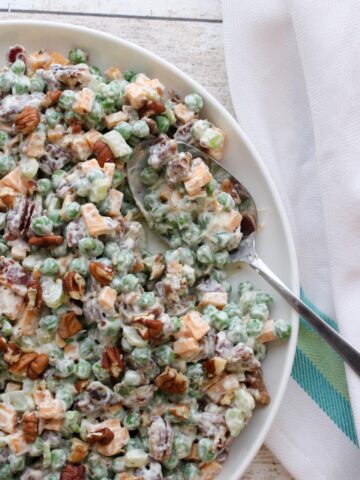 Bowl of Bacon Peas Salad with a spoon