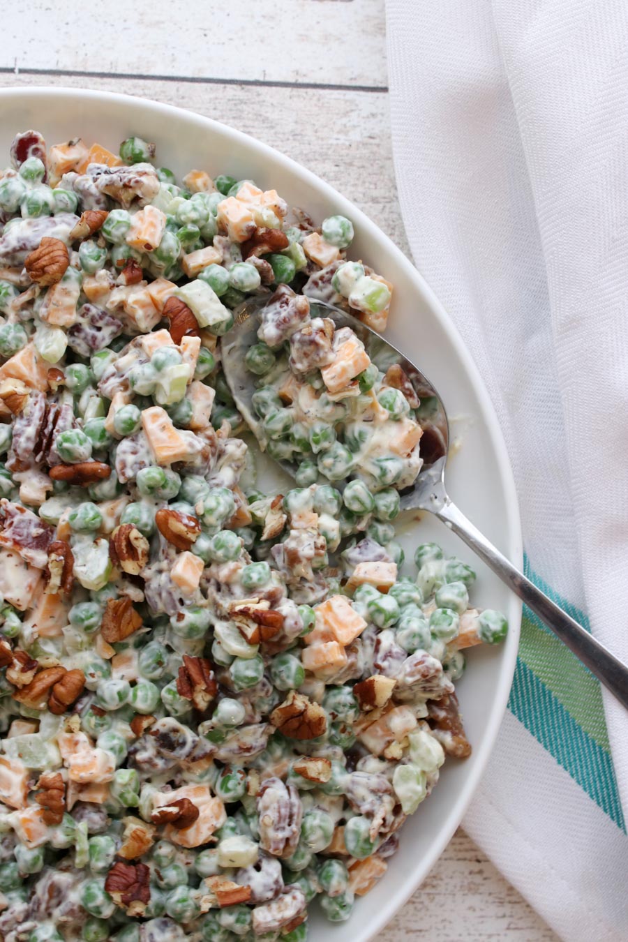 Bowl of Bacon Peas Salad with a spoon