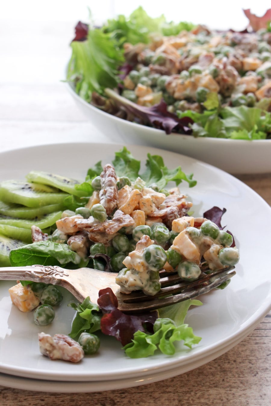 Fork full of bacon pea salad