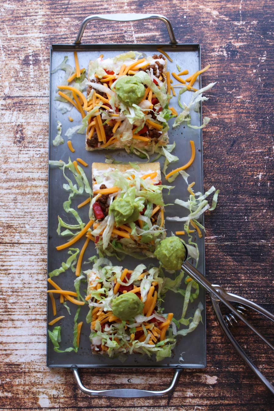 overhead shot of three pieces of taco pizza