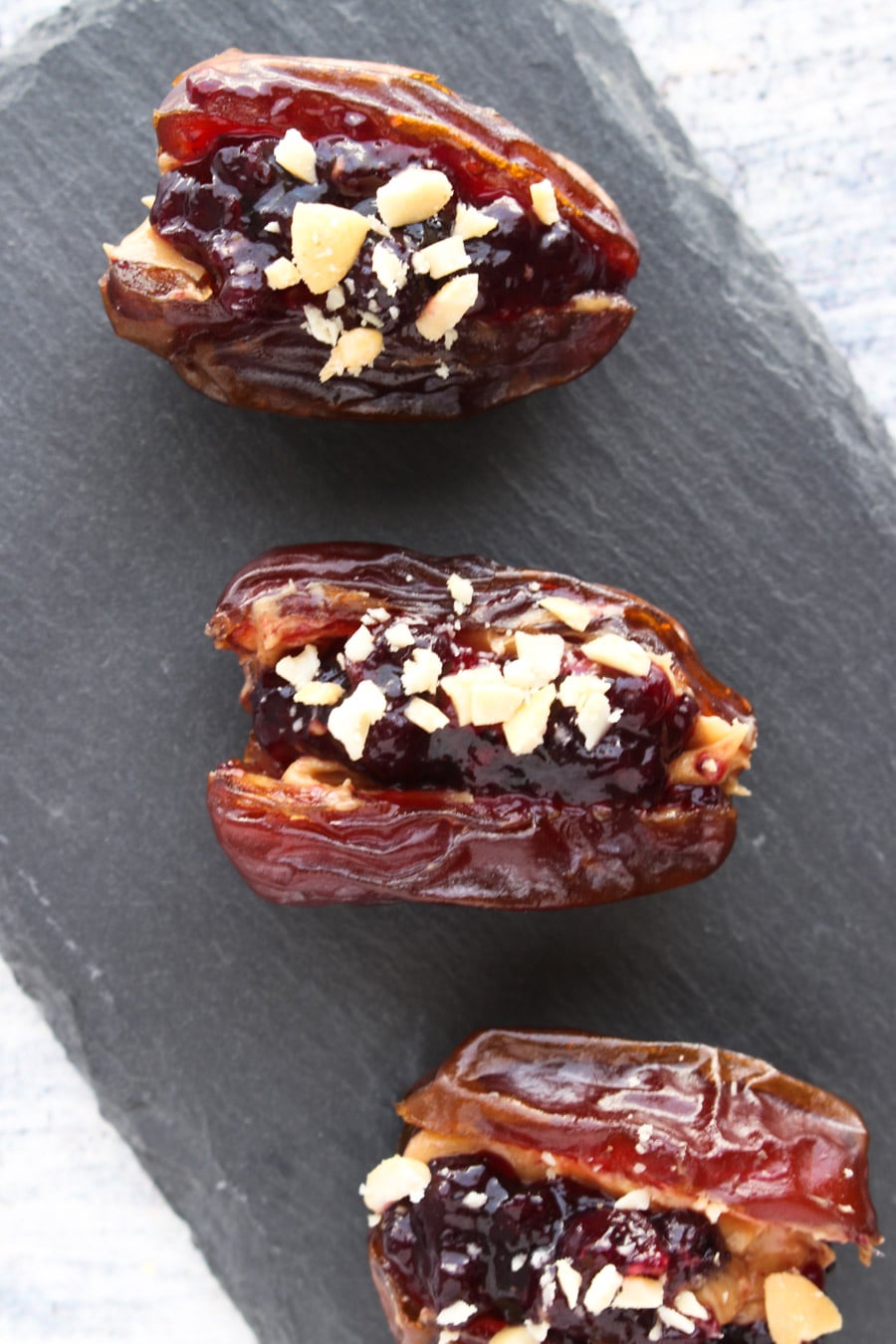 3 Peanut butter and jelly stuffed dates on a tray