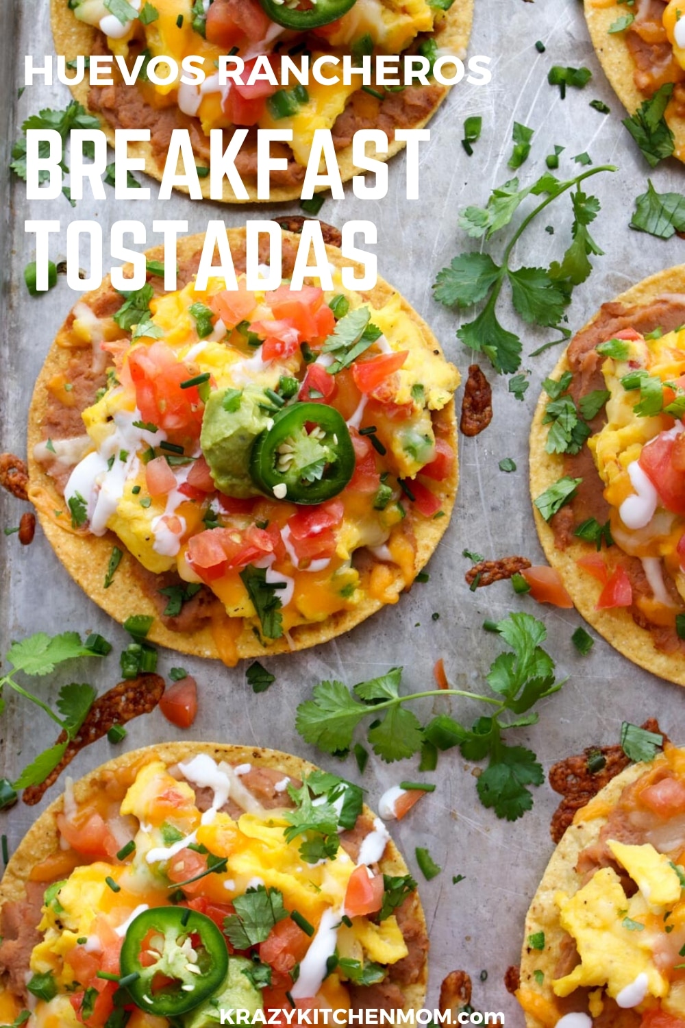 Huevos Rancheros Breakfast Tostadas is a great recipe for breakfast, lunch, or dinner. They're made with creamy refried beans, fluffy scrambled eggs with melted cheese, diced tomatoes, diced, onions, guacamole, sour cream, cilantro, and jalapeños. via @krazykitchenmom