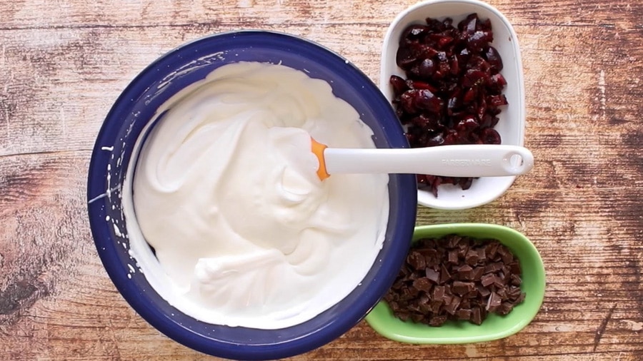 Chopped Cherries and chocolate with bowl of no churn ice cream