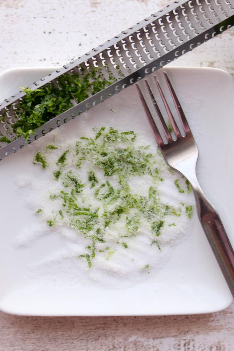 dish with salt, zest, zester and fork