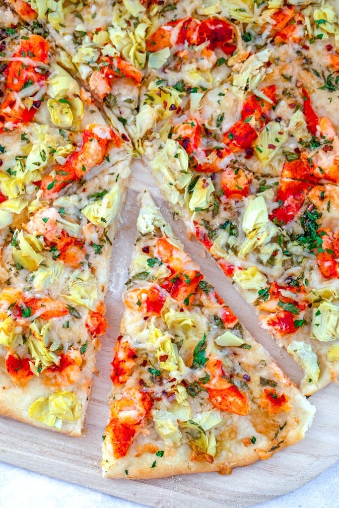 A slice of artichoke and tomato pizza