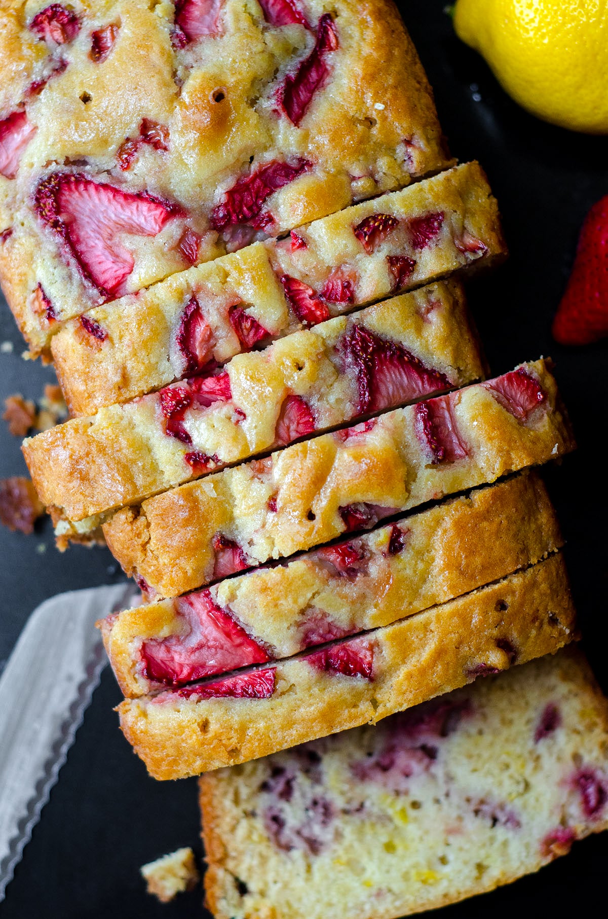 A close up of a piece of cake on a plate, with Strawberry and Lemon