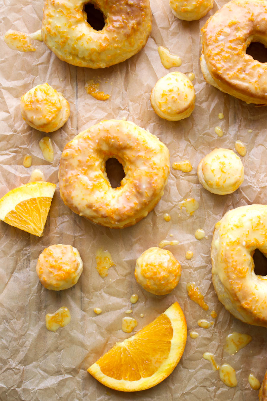 Orange Glazed donuts and donut holes on parchment paper