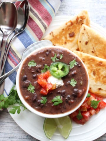 Bowl of black bean soup with quesdillas