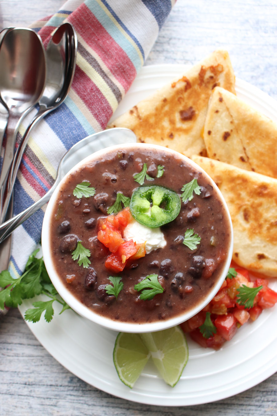 Bowl of black bean soup with quesdillas