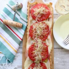 A tomato Tart with a wine glass and cork and cork screw