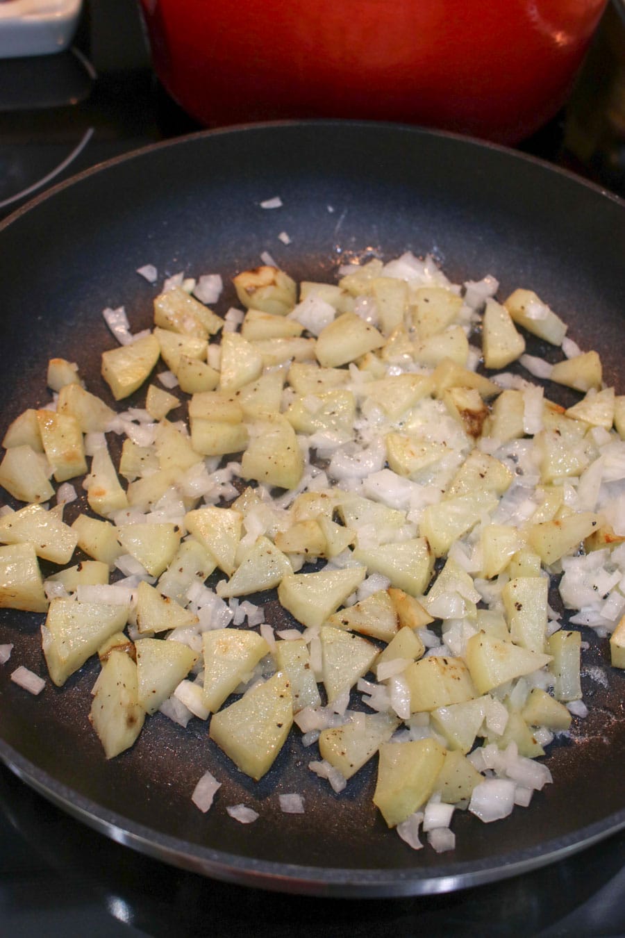 Diced potatoes and onions in a skillet