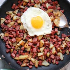 Corned Beef Hash in skillet with sunny side egg on top