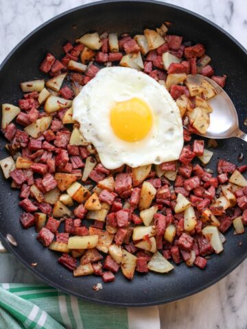 Corned Beef Hash in skillet with sunny side egg on top