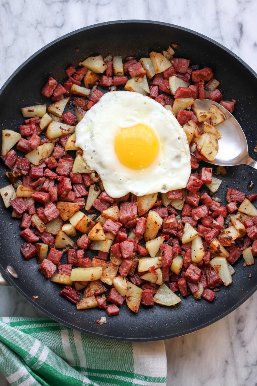 Corned Beef Hash in skillet with sunny side egg on top