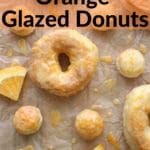 orange glazed donuts and donut holes on parchment papr