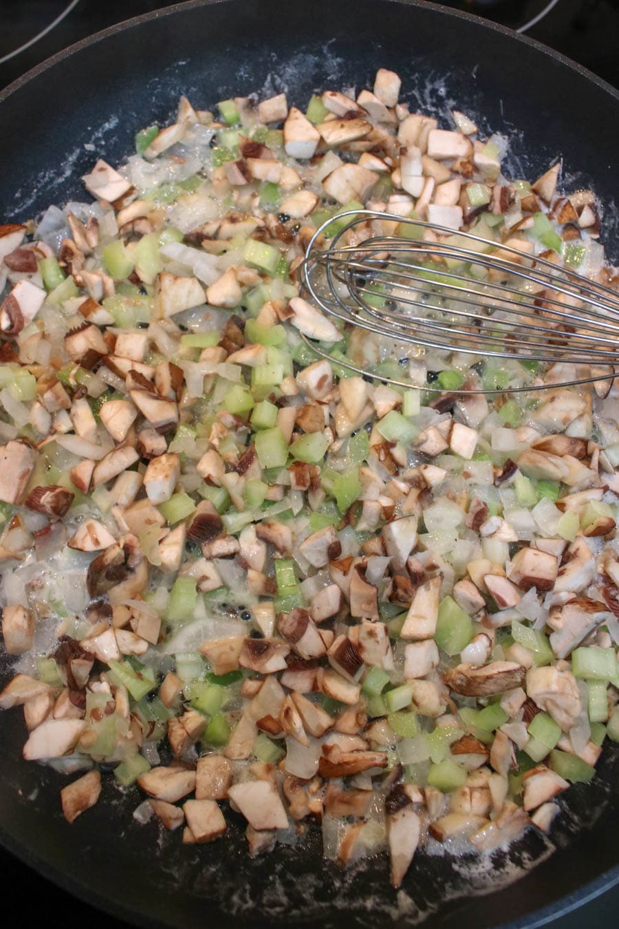 Mushroom, onion, and butter sautéing in a skillet