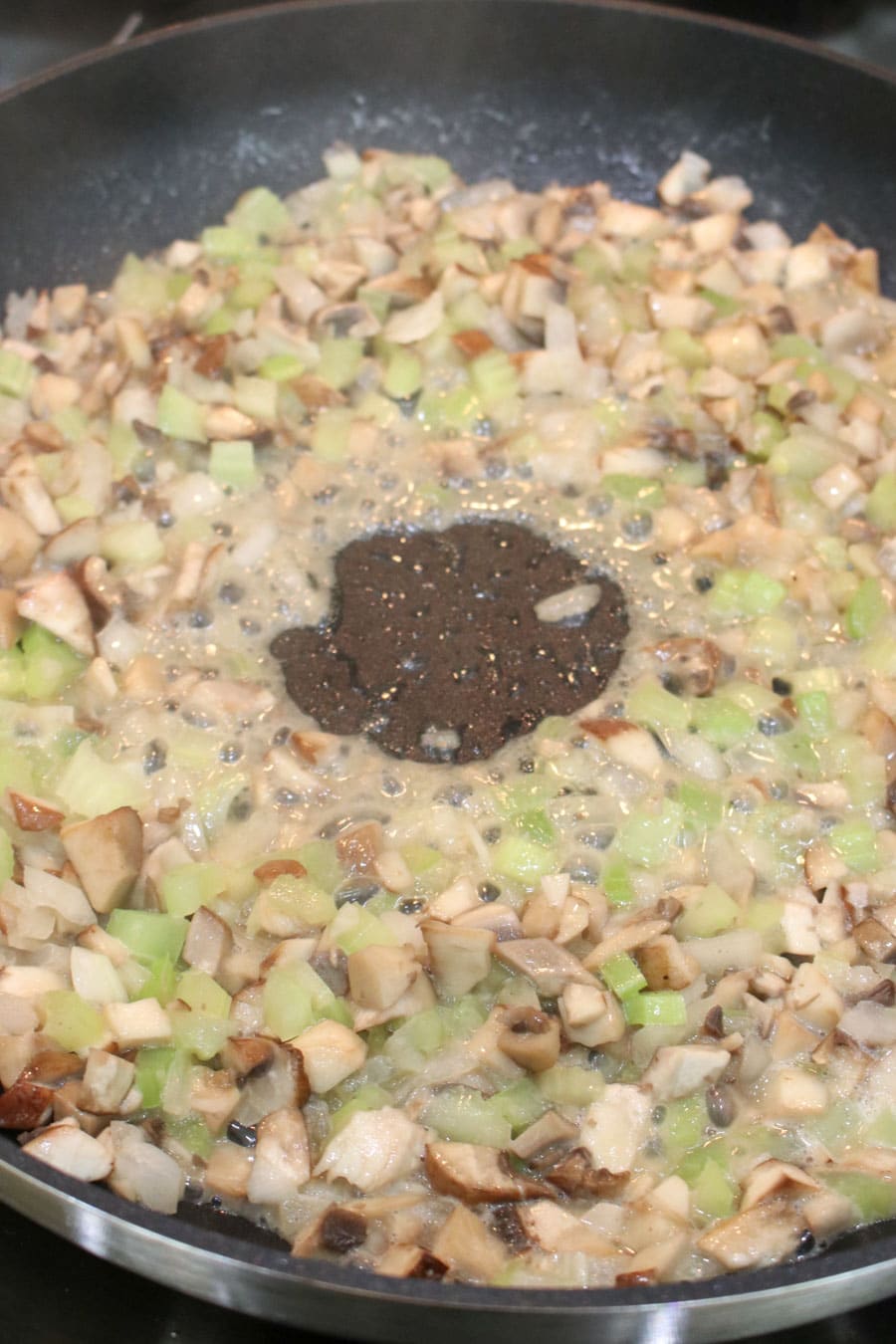 Mushroom, onion, and butter sautéing in a skillet