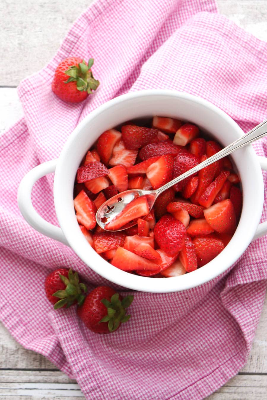 Bowl of strawberries on pink towel