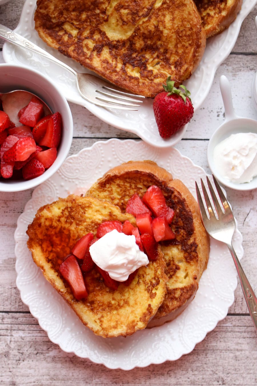 French toast topped with strawberries and sour cream